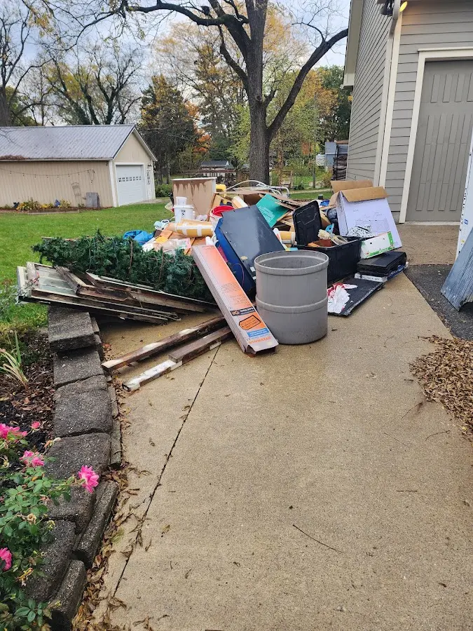 Dumpster being loaded with debris for Roofing Dumpster Rental in Palm Coast